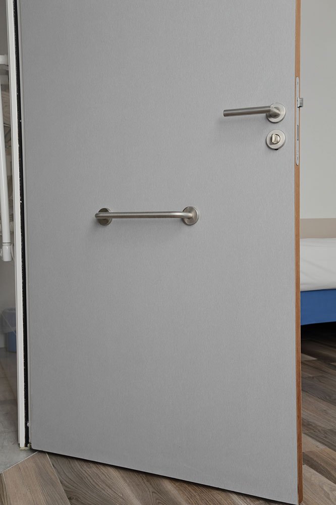 porte équipée pour personne handicapée avec barre de soutien