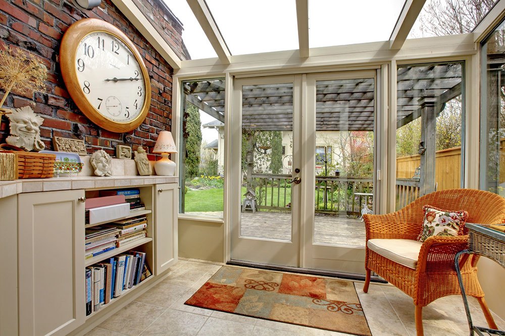 Garden room wall with clock and book shelves